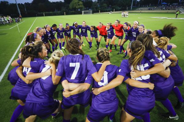 Soccer team huddles before Friday night's match against Oklahoma State. 