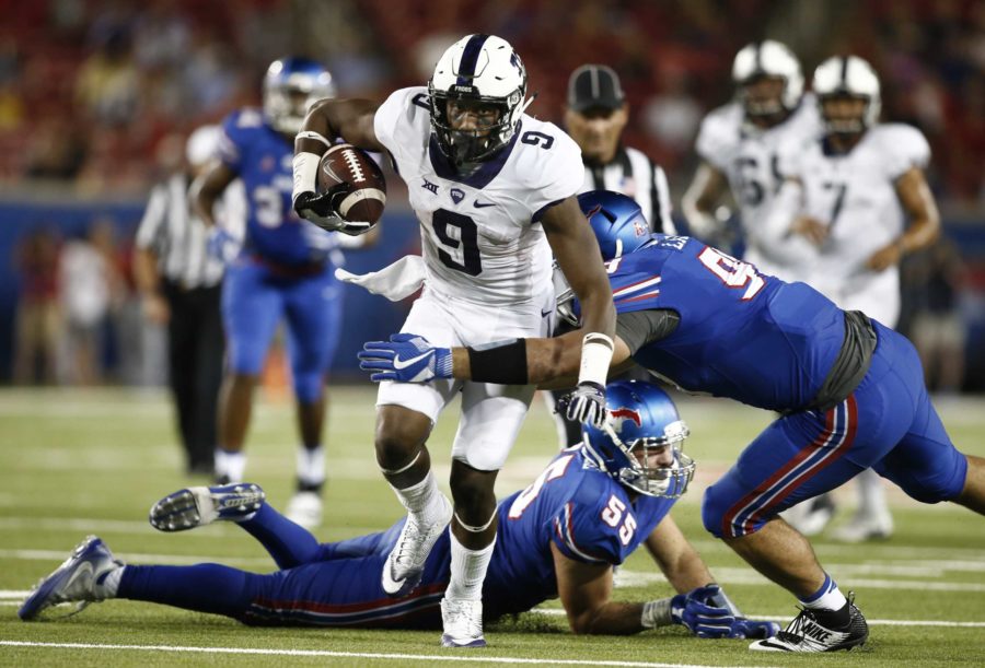 TCU wide receiver John Diarse (9) tries to break loose from SMU defensive end Justin Lawler (99) and linebacker Carlos Carroll (55) in the second half of an NCAA college football game, Saturday, Sept. 23, 2016, in Dallas, Texas. TCU defeated SMU 33-3. (AP Photo/Mike Stone)