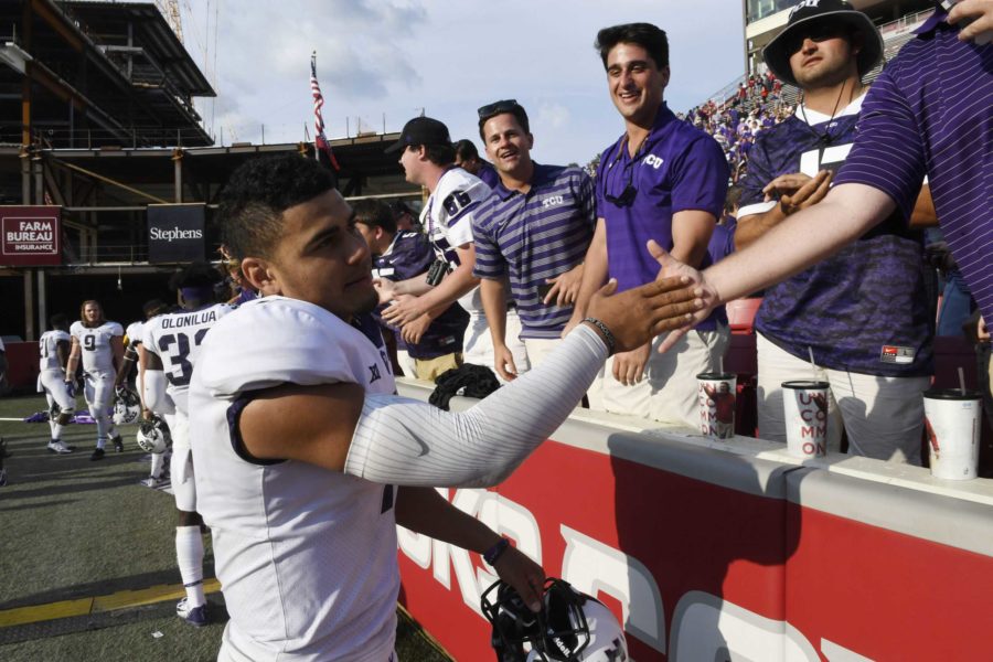 TCU quarterback Kenny Hill celebrates a win over Arkansas with fans after an NCAA college football game in Fayetteville, Ark., Saturday, Sept. 9, 2017.  (AP Photo/Michael Woods)