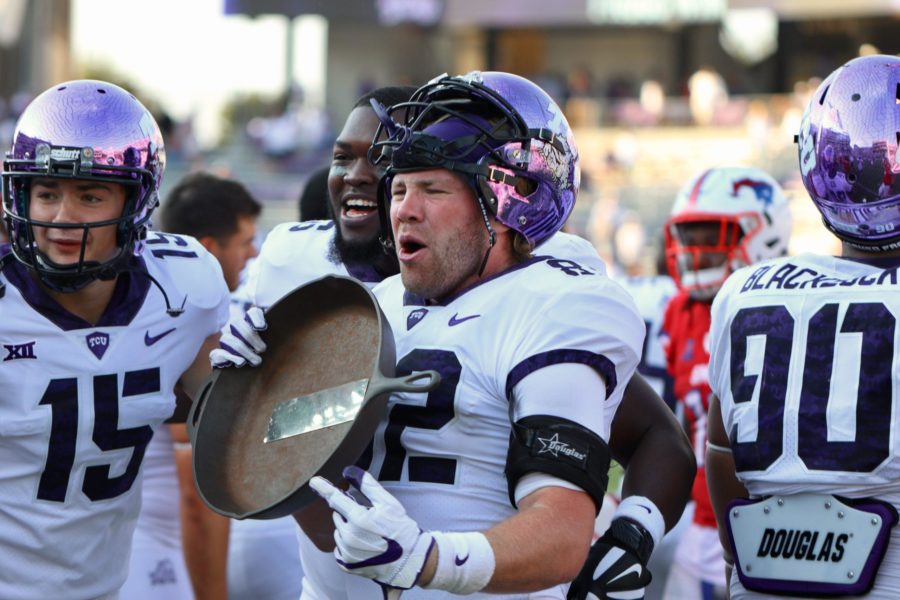 TCU tight end Charlie Reid celebrates the Horned Frogs 56-35 win over SMU with the Iron Skillet. Photo by Sam Bruton. 