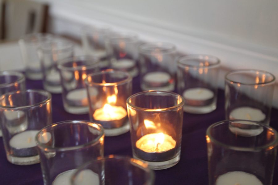 Students lit candles to remember those that are suffering and offer hope. Picture by Ryan Myers