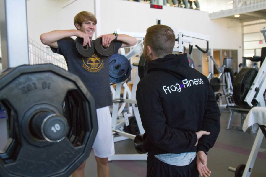 A TCU freshman receives a pep talk from personal trainer, Colton Purcell, during an exercise at the recreation center on Wednesday, Oct. 11, 2017. Photo by Carolina Olivares. 