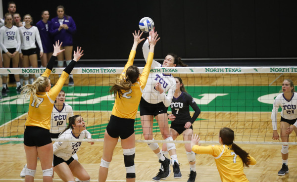 TCU middle blocker Anna Walsh spikes the ball past the Wyoming front line. Photo courtesy of GoFrogs.com
