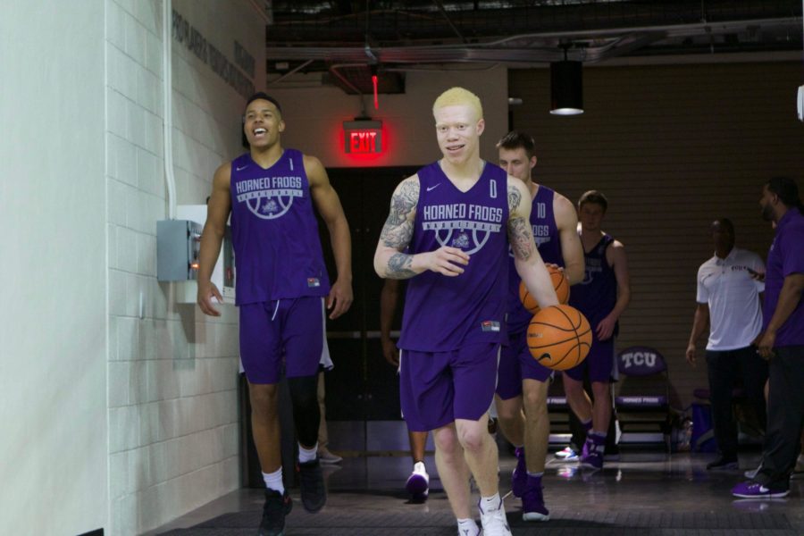 Jaylen Fisher (0) and Desmond Bane (1) lead the Purple out onto the court. Photo by Carolina Olivares
