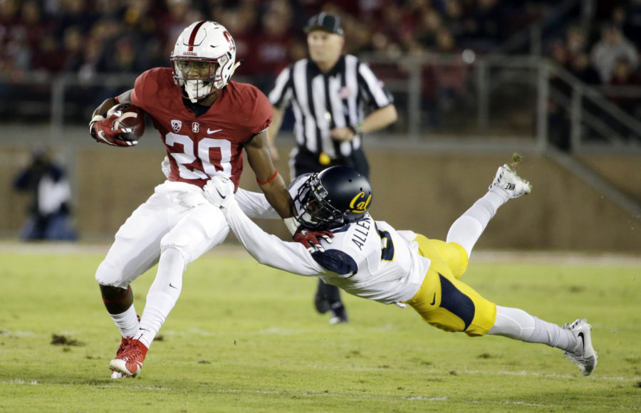 Stanford running back Bryce Love (20) is tackled by California cornerback Darius Allensworth (2) during the first half of an NCAA college football game Saturday, Nov. 21, 2015, in Stanford, Calif. (AP Photo/Marcio Jose Sanchez)