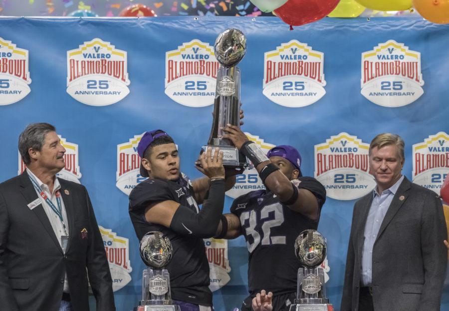 TCU quarterback Kenny Hill and TCU linebacker Travis Howard hoist the Alamo Bowl trophy. Photo by Cristian ArguetaSoto