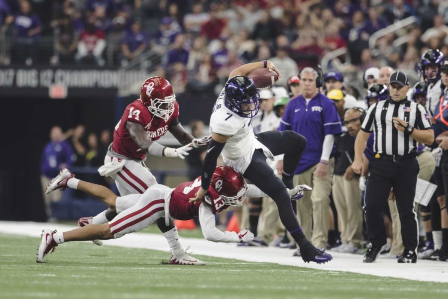 Kenny Hill is shoved out of bounds by a couple Oklahoma defenders. Photo by Cristian ArguetaSoto
