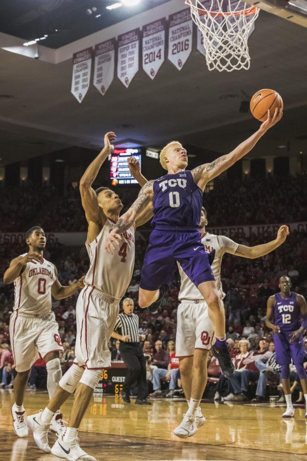 TCU guard Jaylen Fisher drives to the hoop against Oklahomas Jamuni McNeace during a Jan. 13 game in Norman. Photo by Cristian ArguetaSoto