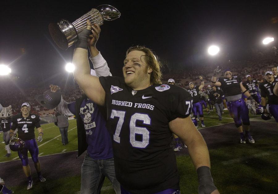 TCU center Jake Kirkpatrick (76) celebrates with the Rose Bowl trophy after TCU, defeated the Wisconsin Badgers at the Rose Bowl NCAA college football game on Saturday, Jan. 1, 2011, in Pasadena, Calif. (AP Photo/Marcio Sanchez)