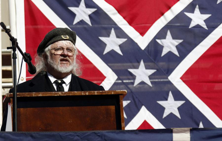 Mike Webb, a Sons of Confederate Veterans officer, stands before an oversized Mississippi state flag and speaks about the importance of keeping the Confederate battle emblem on the flag, at a rally with other pro flag groups at the state Capitol in Jackson, Miss., Tuesday, Jan. 19, 2016. (AP Photo/Rogelio V. Solis)