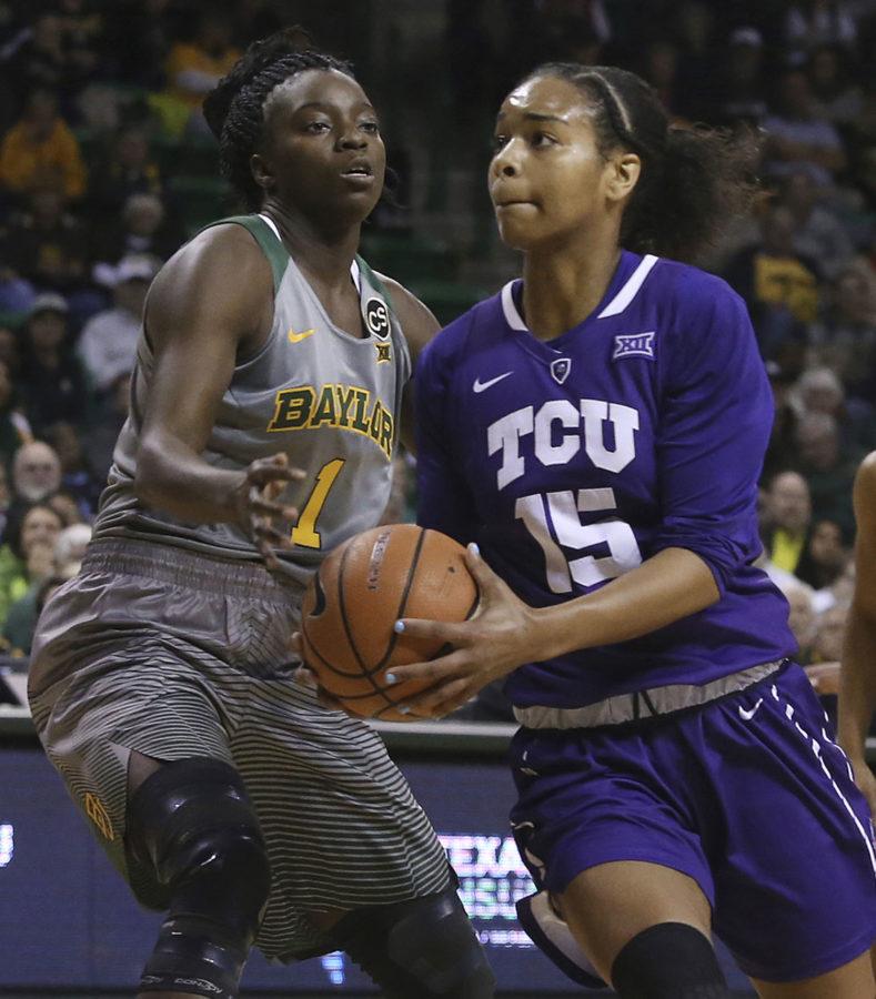 TCU guard Jayde Woods (15) drives against Baylor forward Dekeiya Cohen (1) during the first half of an NCAA college basketball game Saturday, Feb. 10, 2018, in Waco, Texas. (AP Photo/Jerry Larson)