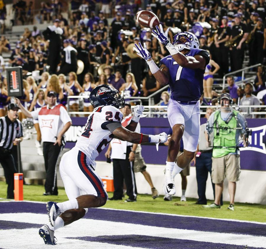 TCU wide receiver Kolby Listenbee (7) catches a touchdown pass in front of Samford safety Trey Wesley (24) in the second half of an NCAA college football game in Fort Worth, Texas, Saturday, Aug. 30, 2014. TCU won 48-14. (AP Photo/Jim Cowsert)
