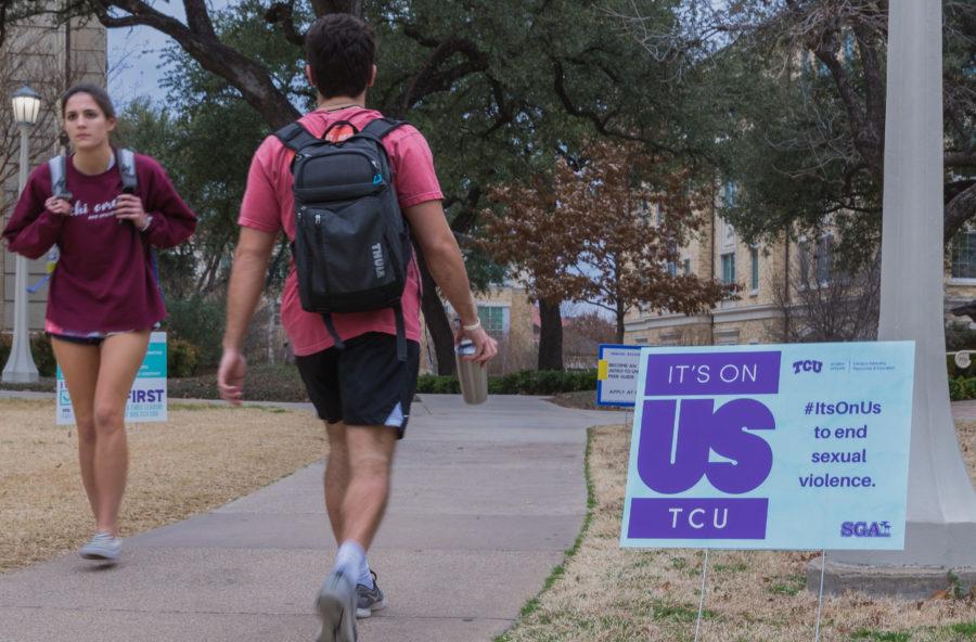 Students walk past one of many Its on Us posters on campus. Photo taken Feb. 19 in Fort Worth, Texas by Cristian ArguetaSoto. 