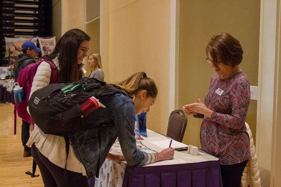 Students sign up for more information during the Study Abroad Fair held on Feb. 7 in the BLUU Auditorium. (Photo by Michelle Carter)
