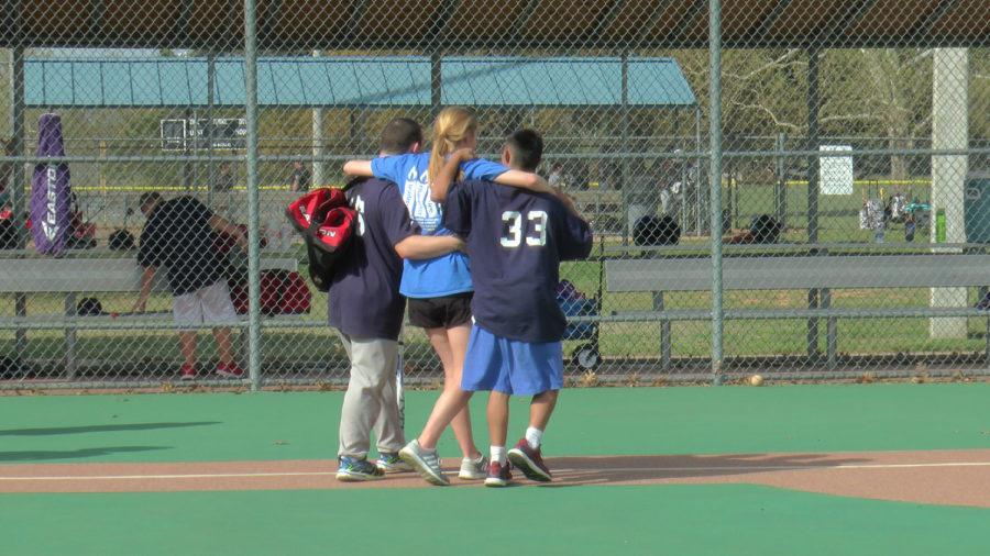 Miracle League volunteer congratulates players on a win.