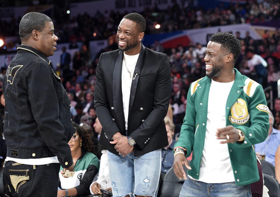 Actor Tracy Morgan, left, greets Dwyane Wade, center, of the Miami Heat, and actor Kevin Hart during the NBA All-Star basketball Three Point contest, Saturday, Feb. 17, 2018, in Los Angeles. (AP Photo/Chris Pizzello)