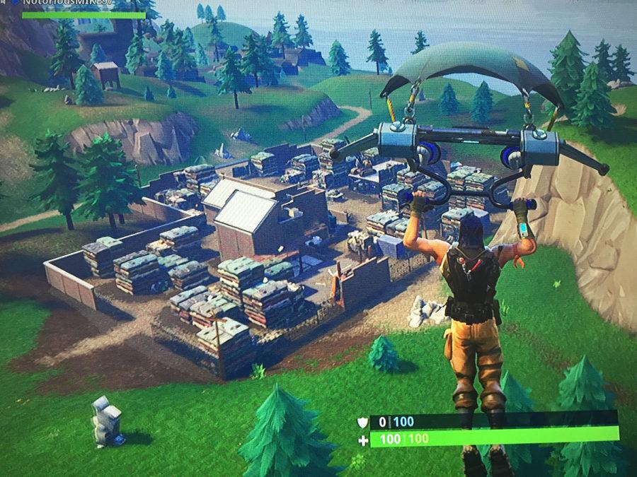 In+game+Fortnite+action+as+a+player+parachutes+down+to+where+they+will+be+their+game.