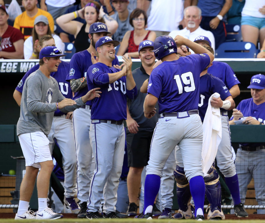 TCUs Luken Baker (19) celebrates with his teammates after hitting a home run against Coastal Carolina during the second inning of an NCAA College World Series baseball game, Tuesday, June 21, 2016, in Omaha, Neb. (AP Photo/Nati Harnik)