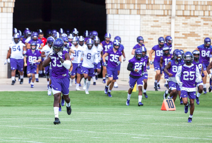 The Horned Frogs jog out to the practice field Saturday.