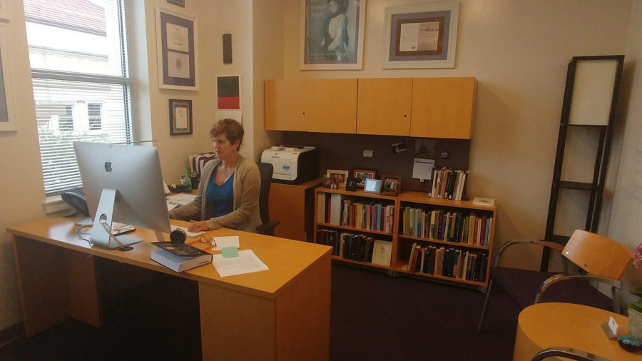 Dr. Karen Steele, the new dean of Interdisciplinary Studies, answer emails on her computer (photo by Richard Edgemon)