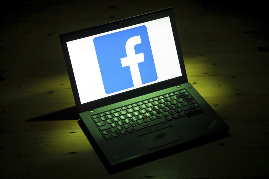 Laptop computer with Facebook logo on screen