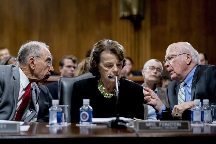 Senate Judiciary Committee Chairman Chuck Grassley, R-Iowa, left, accompanied by Sen. Dianne Feinstein, D-Calif., the ranking member, center, speaks with Sen. Patrick Leahy, D-Vt., right, during a Senate Judiciary Committee markup meeting on Capitol Hill, Thursday, Sept. 13, 2018, in Washington. The committee will vote next week on whether to recommend President Donald Trumps Supreme Court nominee, Brett Kavanaugh for confirmation. Republicans hope to confirm him to the court by Oct. 1.(AP Photo/Andrew Harnik)