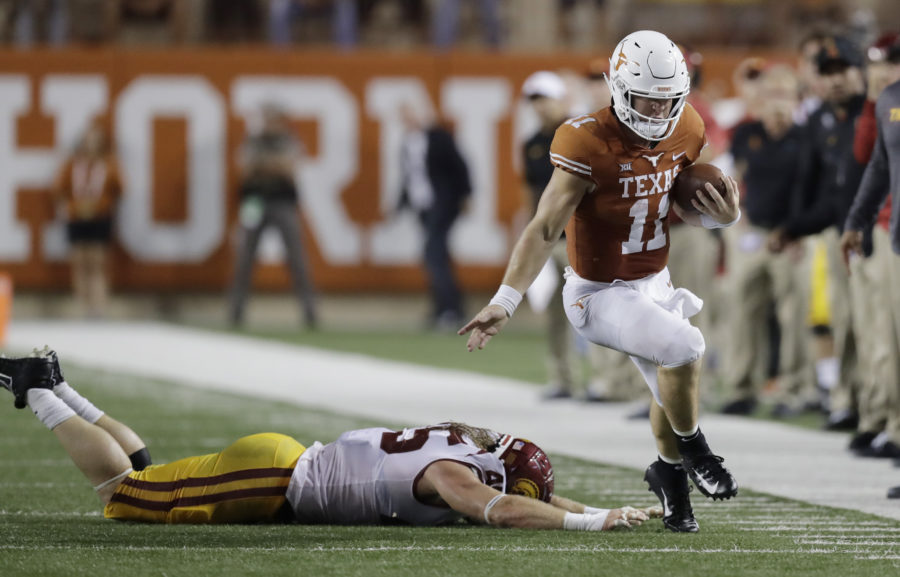 Texas quarterback Sam Ehlinger (11) works to stay in bounds as he runs past Southern California linebacker Porter Gustin (45) during the first half of an NCAA college football game, Saturday, Sept. 15, 2018, in Austin, Texas. (AP Photo/Eric Gay)