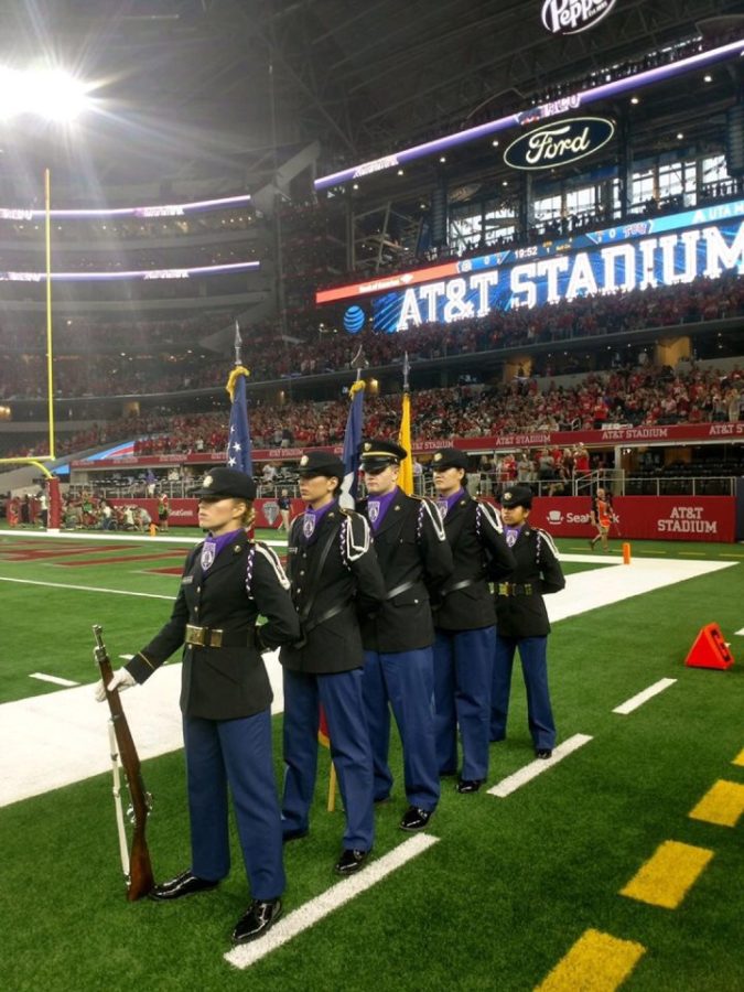 Dunkleberger and Longoria stand on the field at AT&T Stadium representing TCU Color Guard.  (Photo Courtesy Issie Dunkleberger)