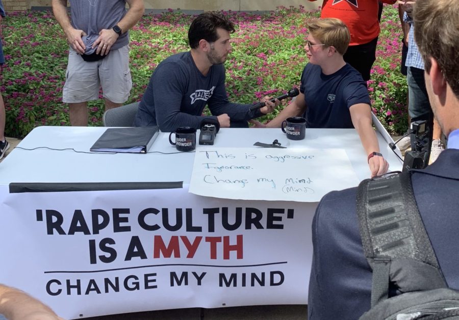 Steven Crowder campus to campus with a sign saying: Rape culture is a myth, change my mind