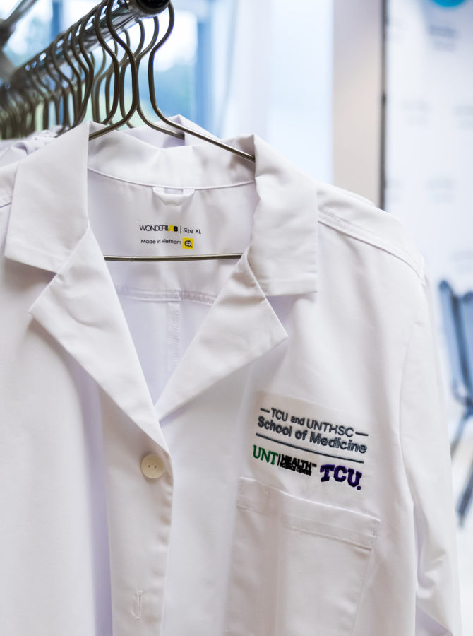 White coats stand on display at the TCU and UNTHSC School of Medicine announcement event in 2018. (Cristian ArguetaSoto/Staff Photographer)
