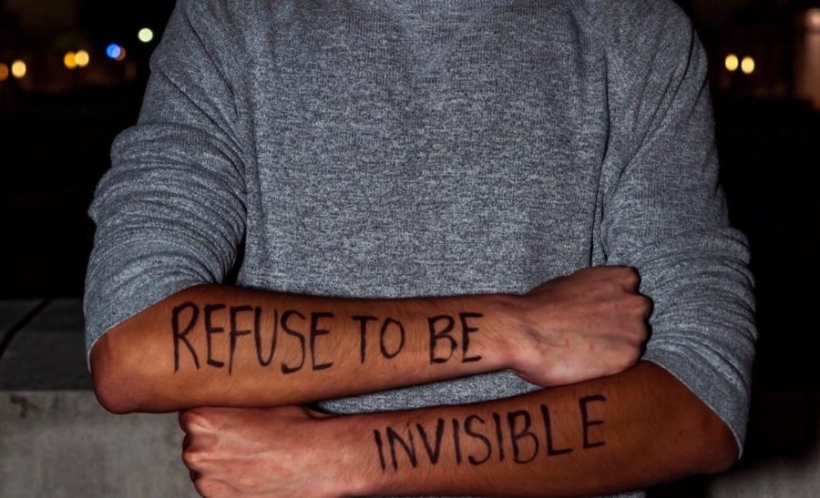 Isaac Portillo, a junior at TCU, poses with his message on his arms. Photo courtesy of Cristian Soto.