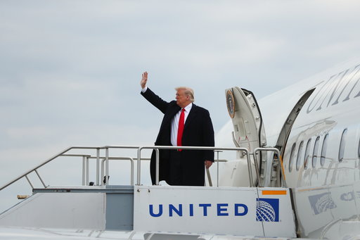 President Donald Trump boards Air Force One at Indianapolis International Airport in Indianapolis, Saturday, Oct. 27, 2018, to travel to Murphysboro, Ill. for a rally. (AP Photo/Andrew Harnik)
