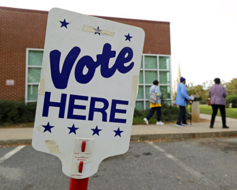 FILE- In this Oct. 23, 2018, file photo people arrive for early voting at a polling place in Charlotte, N.C. Companies aren’t required to shut down on Nov. 6, for the election, but many give their staffers paid time off to go to the polls , 44 percent, according to a survey by the Society for Human Resources Management, a trade group. Small business owners who wonder what to do should first check their state and local laws. (AP Photo/Chuck Burton, File)