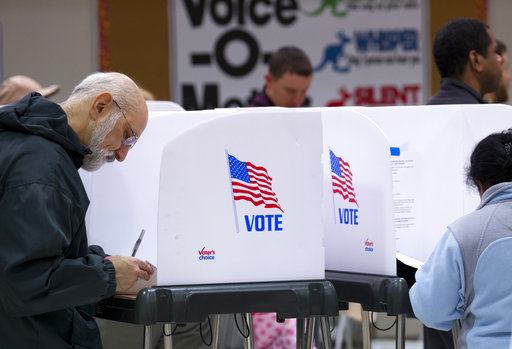 People fill out their ballots during election day, Tuesday, Nov. 6, 2018, in Silver Spring, Md. (AP Photo/Jose Luis Magana)