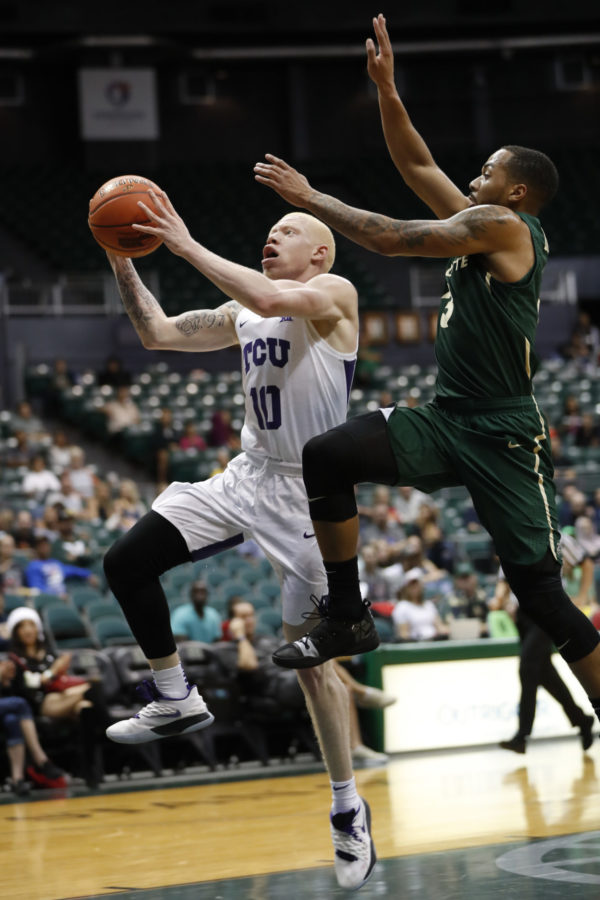 TCU guard Jaylen Fisher (10) goes to the basket in front of Charlotte guard Jon Davis (3) during the first half of an NCAA college basketball game at the Diamond Head Classic, Saturday, Dec. 22, 2018, in Honolulu. (AP Photo/Marco Garcia)