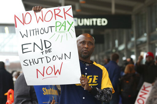 Federal employee Marcus Walker joined other federal employees and supporters at the Sacramento International Airport calling for President Donald Trump and Washington lawmakers to end the partial government shutdown, Wednesday, Jan. 16, 2019, in Sacramento, Calif. (AP Photo/Rich Pedroncelli)