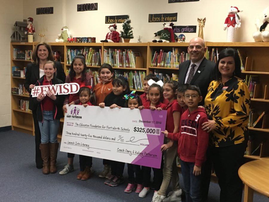 Kelsey Patterson (far left) presents a $325,000 check on behalf of the Gary Patterson Foundation to Fort Worth ISD for 38 elementary schools. Photo by Garrett Podell. 