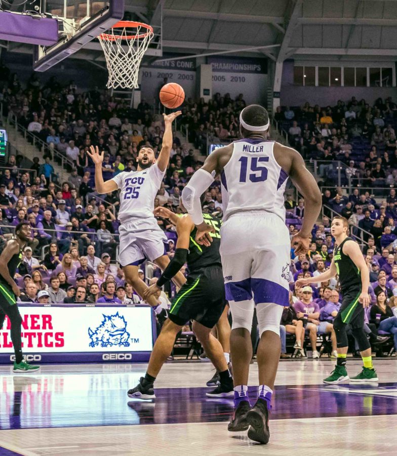 TCU guard Alex Robinson drives to the hoop against Baylor while TCU forward JD Miller (15) stands by in the event of an offensive rebound opportunity. Photo by Cristian ArguetaSoto. 