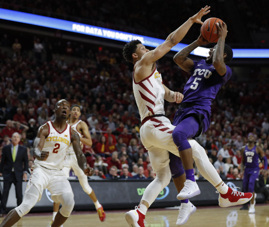 TCU guard Kendric Davis, right, drives to the lane for a shot as Iowa State guard Lindell Wigginton, center, defends during the second half of an NCAA college basketball game, Saturday, Feb. 9, 2019, in Ames. TCU won 92-83. (AP Photo/Matthew Putney)
