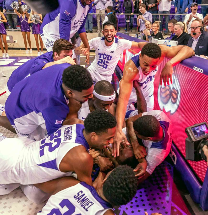 JD Millers teammates dogpile the senior forward after he hit the game-winner jumper against Oklahoma State on Feb. 6. Photo by Cristian ArguetaSoto. 