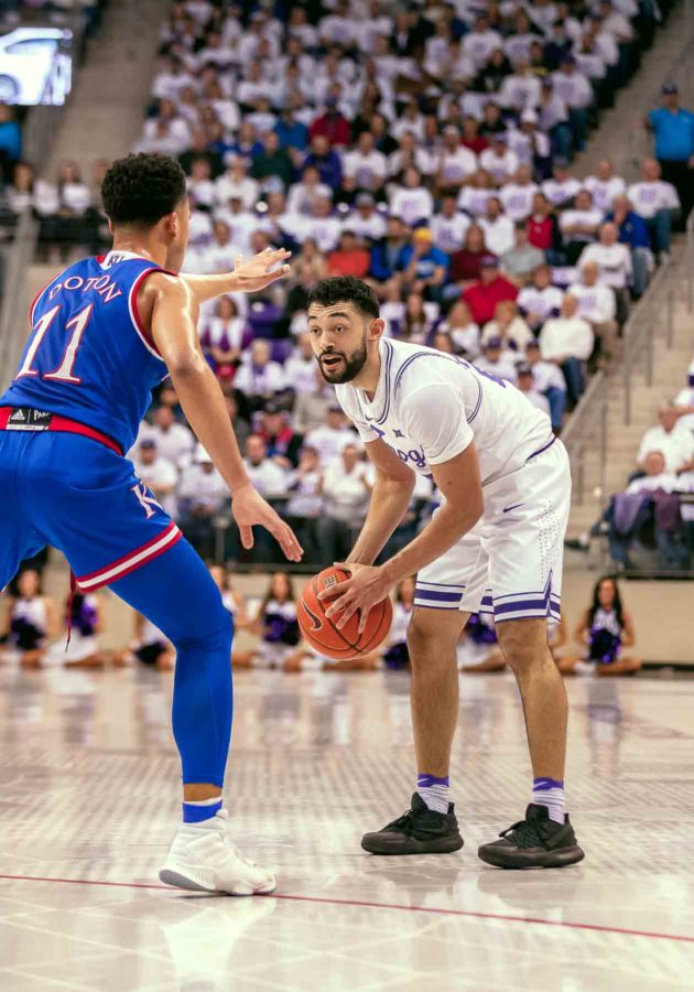 TCU+point+guard+Alex+Robinson+directs+the+offense+while+being+guarded+by+Kansas+point+guard+Devon+Dotson.+Photo+by+Cristian+ArguetaSoto.+