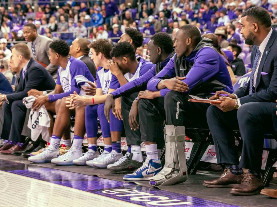 TCU forward Kouat Noi sits on the bench with a boot on his left foot while watching the Horned Frogs play the Oklahoma Sooners in Fort Worth Saturday. Photo by Cristian ArguetaSoto.