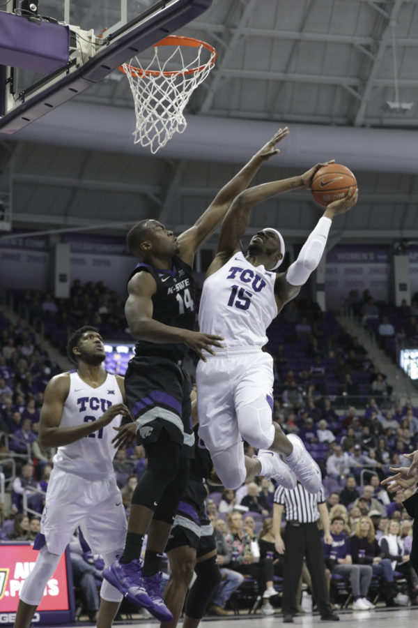 TCU forward JD Miller attempts a lay-up against K-State center Makol Mawien. Photo by Heesoo Yang. 