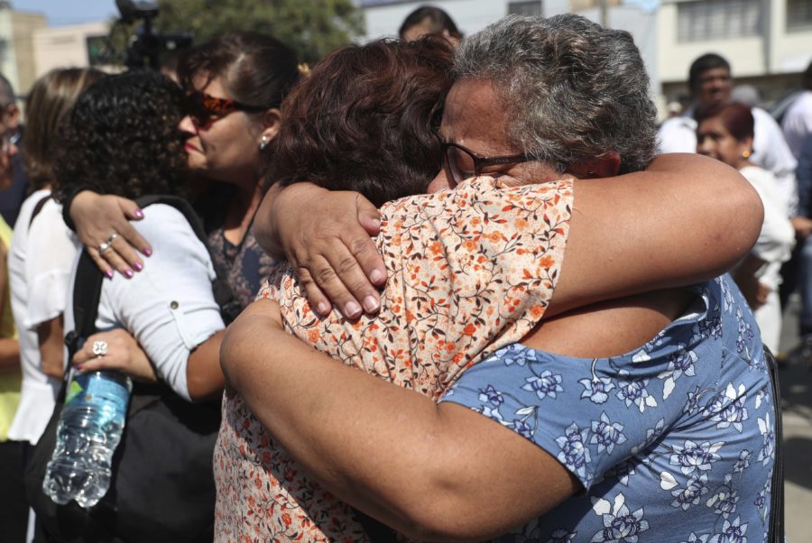 Supporters of former Peruvian President Alan Garcia cry as they learn that the former leader died from a self-inflicted gun shot, outside the hospital where he was taken after he shot himself, in Lima, Peru, Wednesday, April 17, 2019. Perus current President Martinez Vizcarra said Garcia, the 69-year-old former head of state died after undergoing emergency surgery. Garcia shot himself in the head early Wednesday as police came to detain him in connection with a corruption probe. (AP Photo/Martin Mejia)