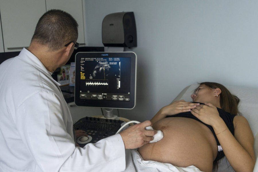 In this photo taken on Jan 19, 2019, a doctor performs an ultrasound examination for Svetlana Mokerova in Miami Beach, Fla. Every year, hundreds of pregnant Russian women, like Mokerova, travel to the United States to give birth so that their child can acquire the privileges of American citizenship. (AP Photo/Iuliia Stashevska)