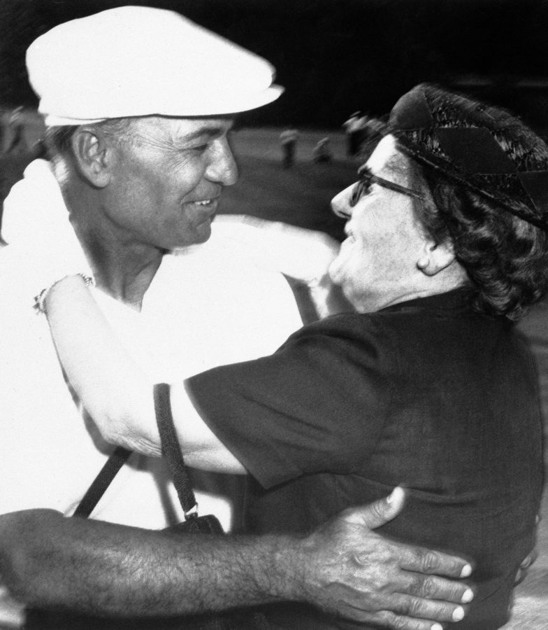 Clara Hogan, mother of Ben Hogan, runs on to the 18th green and hugs her son at Fort Worth, Texas, May 4, 1959, after Ben won the playoff against Fred Hawkins to get the National Colonial Invitation title for the fifth time. Hogan shot a 69 while Hawkins shot a 73. (AP Photo)