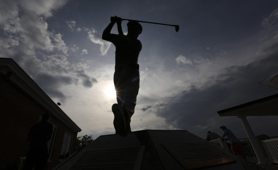 A statue of golfing great Ben Hogan is silhouetted in the sun after the third round of the  Colonial golf tournament in Fort Worth, Texas, Saturday, May 24, 2014.   (AP Photo/LM Otero)