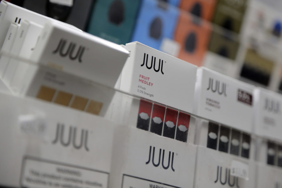 FILE - In this Dec. 20, 2018, file photo Juul products are displayed at a smoke shop in New York. Shares of Altria Group, the nation’s largest tobacco company, fell Thursday, April 25, 2019. Quarterly results were weighed down by $159 million in expenses mainly tied to Altria’s investments in Canadian cannabis investment firm Cronos and Juul, the e-cigarette startup company. (AP Photo/Seth Wenig, File)