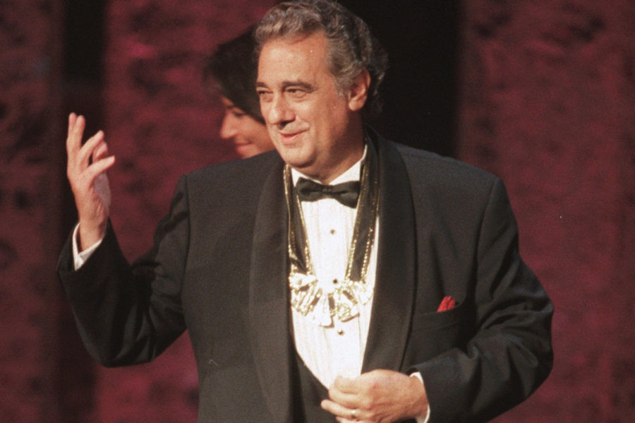 FILE - In this Tuesday, Sept. 14, 1999 file photo, Placido Domingo acknowledges the audience after receiving the 1999 Hispanic Heritage Award at the John F. Kennedy Center for the Performing Arts in Washington. An evening before a performance of “Le Cid,” part of the Washington Opera’s 1999-2000 season, opera singer Angela Turner Wilson said she and Domingo were having their makeup done together when he rose from his chair, stood behind her and put his hands on her shoulders. As she looked at him in the mirror, he suddenly slipped his hands under her bra straps, she said, then reached down into her robe and grabbed her bare breast. It hurt, she told The Associated Press. “It was not gentle. He groped me hard.” She said Domingo then turned and walked away, leaving her stunned and humiliated. (AP Photo/Leslie Kossoff)