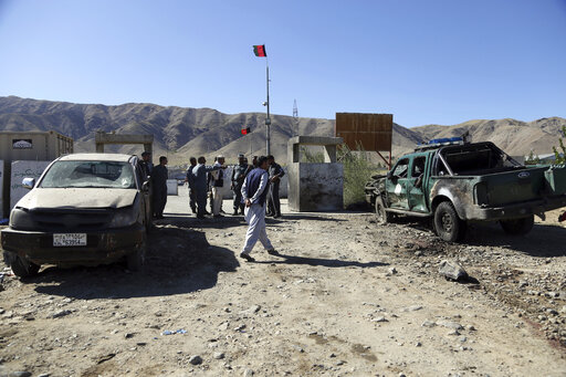 Afghan police inspect the site of a suicide attack, in northern Parwan province, Afghanistan, Tuesday, Sept. 17, 2019. The Taliban suicide bomber on a motorcycle targeted presidential guards who were protecting President Ashraf Ghani at a campaign rally in northern Afghanistan on Tuesday, killing over 20 people and wounding over 30. (AP Photo/Rahmat Gul)